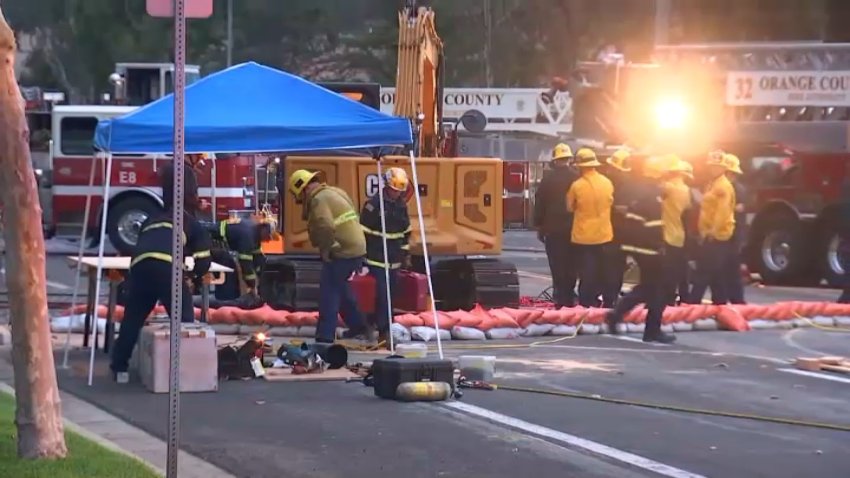 Rescue crews recover the body of a man who was found dead in a partial trench collapse in Tustin on Wednesday, Dec. 20, 2023.